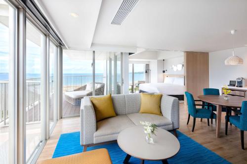 a living room with a couch and a table at Hilton Okinawa Sesoko Resort in Motobu