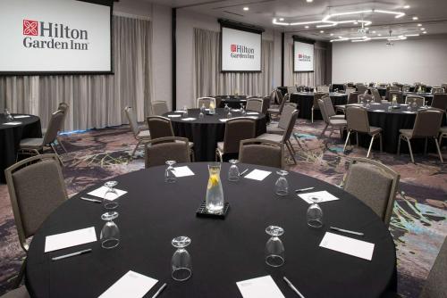 a conference room with round tables and chairs with wine glasses at Hilton Garden Inn Seattle Lynnwood, Wa in Lynnwood