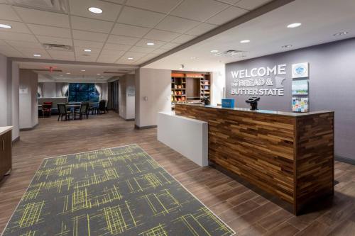 a lobby of a office with a welcome sign and a counter at Hampton Inn Eden Prairie Minneapolis in Eden Prairie