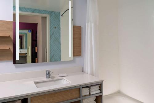 a bathroom with a sink and a mirror at Hilton Garden Inn Ocala Downtown, Fl in Ocala