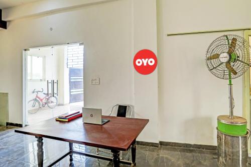 a room with a table with a laptop on it at Super OYO Flagship Sunrise Inn in Lucknow