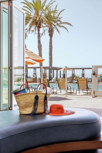 a hat and a basket on top of a table at The Cassara Carlsbad, Tapestry Collection By Hilton in Carlsbad