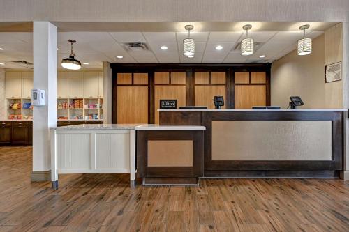 an office lobby with a reception desk and a counter at Homewood Suites by Hilton Albuquerque Airport in Albuquerque