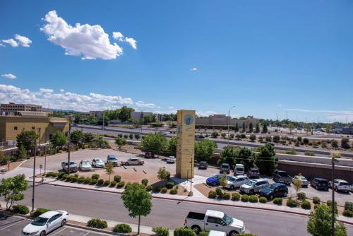 a parking lot with a clock tower in a parking lot at Hampton Inn Albuquerque - University/Midtown in Albuquerque