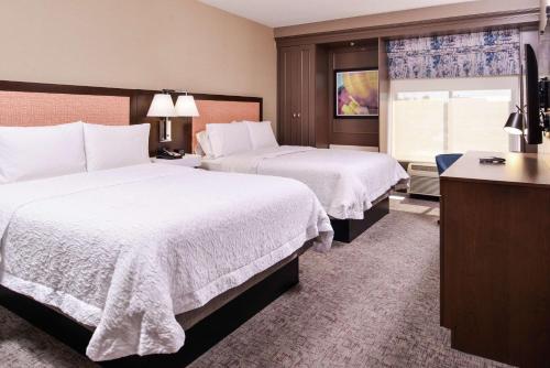 a hotel room with two beds and a window at Hampton Inn Albuquerque - University/Midtown in Albuquerque