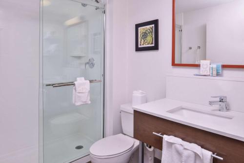 a bathroom with a toilet and a sink and a shower at Hampton Inn Albuquerque - University/Midtown in Albuquerque