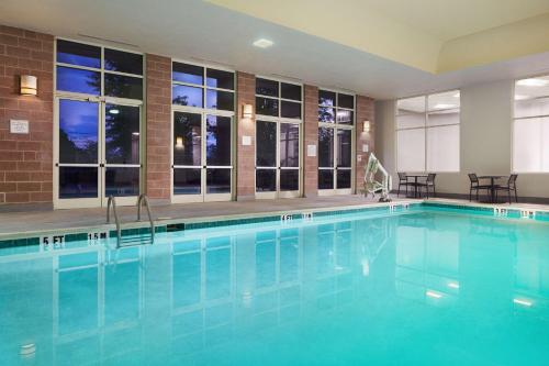 a swimming pool with blue water in a hotel at Hilton Charlotte Airport Hotel in Charlotte