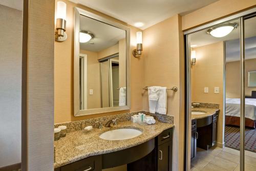 a bathroom with two sinks and a large mirror at Homewood Suites by Hilton Bel Air in Riverside