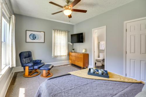 a bedroom with a bed and a chair and a ceiling fan at High Point Vacation Rental with Private Deck and Yard! in High Point