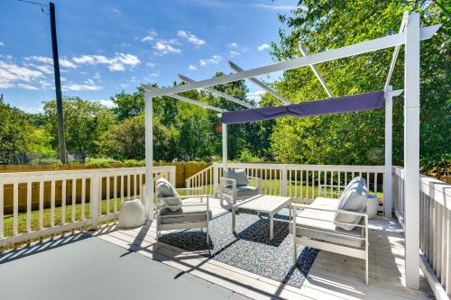 a deck with chairs and a pergola at High Point Vacation Rental with Private Deck and Yard! in High Point