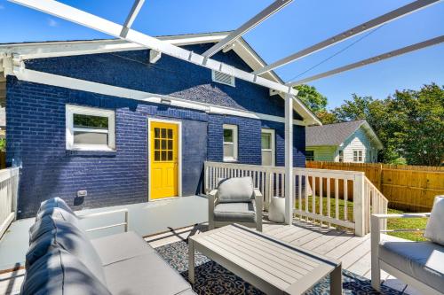 a patio with a blue house with a yellow door at High Point Vacation Rental with Private Deck and Yard! in High Point