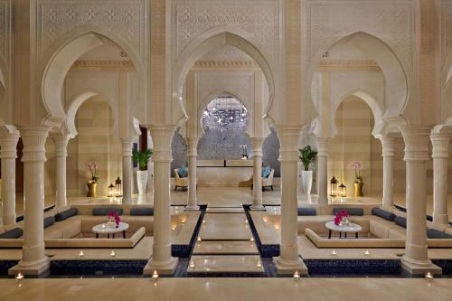 an image of a mosque with columns and tables at Hilton Salwa Beach Resort and Villas in Abū Samrah