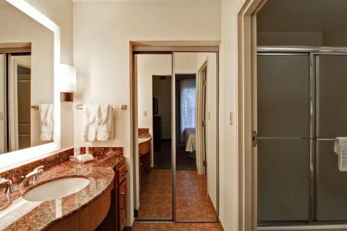 a bathroom with a sink and a shower at Homewood Suites by Hilton Oklahoma City-West in Oklahoma City