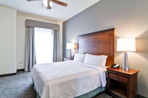 a hotel room with a large bed and two lamps at Homewood Suites by Hilton Oklahoma City-West in Oklahoma City