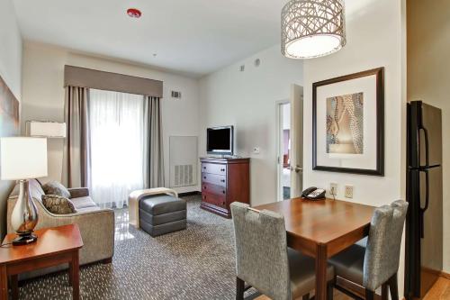 a living room with a table and a dining room at Homewood Suites by Hilton Oklahoma City-West in Oklahoma City