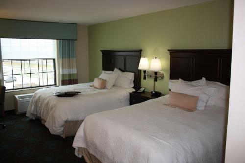 a hotel room with two beds and a window at Hampton Inn and Suites St. Cloud in Saint Cloud