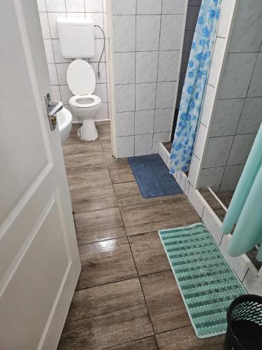 a bathroom with a toilet and two mats on the floor at 7DAB 8 contactless self check-in in Budapest