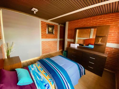 a bedroom with a bed and a dresser and a mirror at Depto Nuevo cerca del foro sol "Andy" in Mexico City