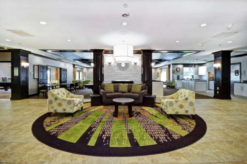 a lobby with a couch and chairs on a rug at Homewood Suites by Hilton Atlanta-Galleria/Cumberland in Atlanta