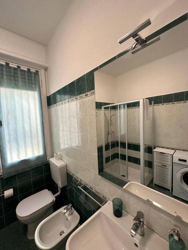 a bathroom with a sink and a toilet and a mirror at La Casa di Gi&Vi in Sanremo