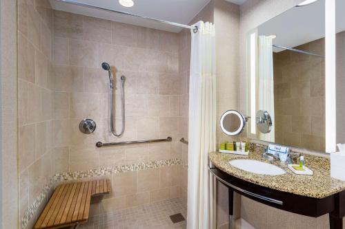 a bathroom with a sink and a shower at Hilton Americas - Houston in Houston
