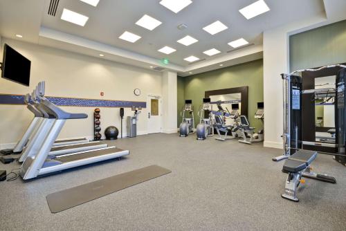 a gym with treadmills and machines in a room at Hampton Inn & Suites Charleston Airport in Charleston