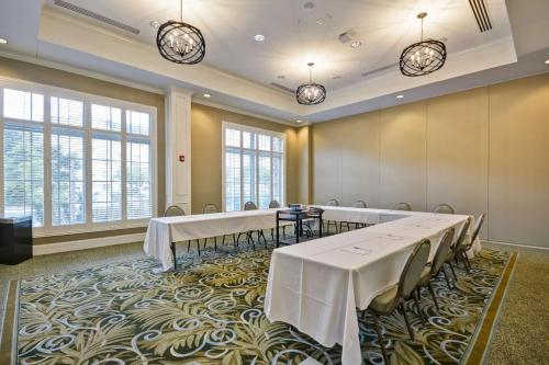a conference room with tables and chairs and windows at Hampton Inn & Suites Charleston Airport in Charleston