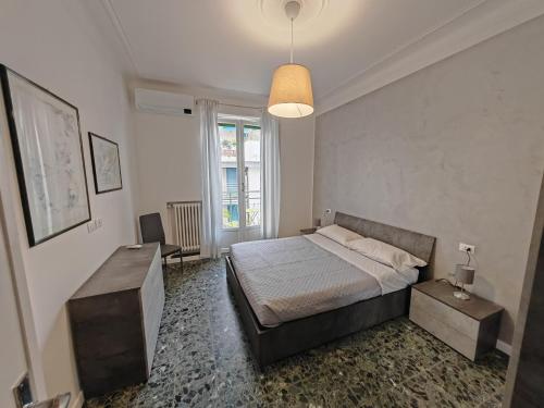 a bedroom with a bed and a table in it at La Casa di Gi&Vi in Sanremo