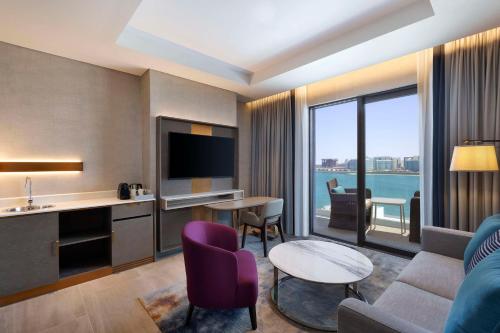 a hotel room with a living room with a view at Hilton Abu Dhabi Yas Island in Abu Dhabi