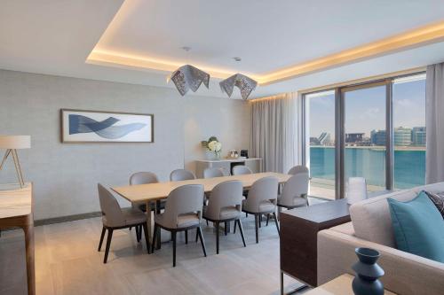 a living room with a table and chairs and a couch at Hilton Abu Dhabi Yas Island in Abu Dhabi