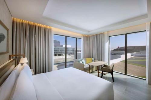 a hotel room with a large bed and a desk at Hilton Abu Dhabi Yas Island in Abu Dhabi