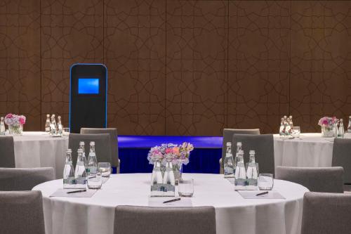 a set of tables in a room with a cell phone at Hilton Abu Dhabi Yas Island in Abu Dhabi