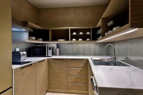 a kitchen with a sink and a microwave at Hilton Abu Dhabi Yas Island in Abu Dhabi