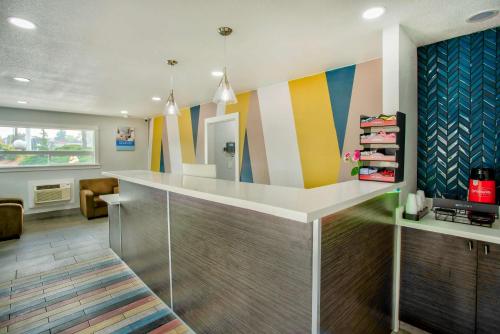 a lobby with colorful walls and a reception counter at Studio 6 Suites - Albany, OR in Albany