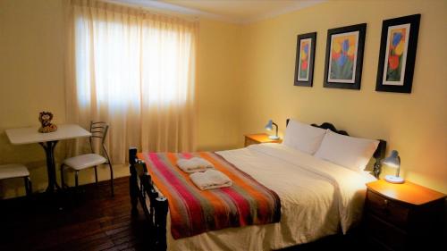 a bedroom with a bed with towels on it at Eco Aventura Hostel Cusco in Cusco
