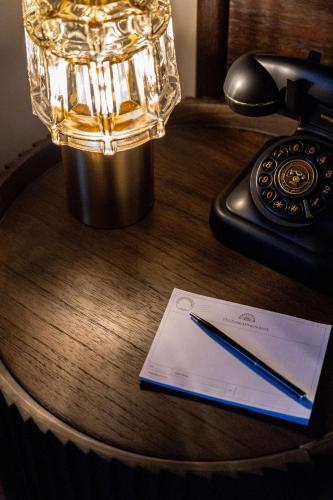 a pen and a paper on a desk with a phone at Telegraphenamt in Berlin