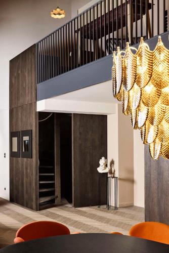 a dining room with a staircase and a chandelier at Telegraphenamt in Berlin