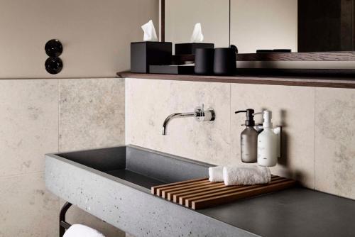 a kitchen sink with a soap dispenser on a counter at Telegraphenamt in Berlin