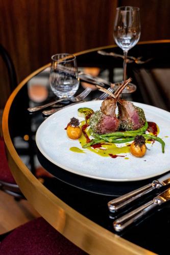 a plate of food on a table with wine glasses at Telegraphenamt in Berlin