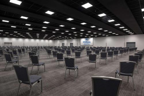 a room with rows of chairs in a building at Hilton Geneva Hotel and Conference Centre in Geneva