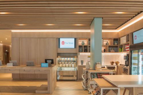 a store with tables and a food court in a store at Hilton Garden Inn Umhlanga Arch in Durban