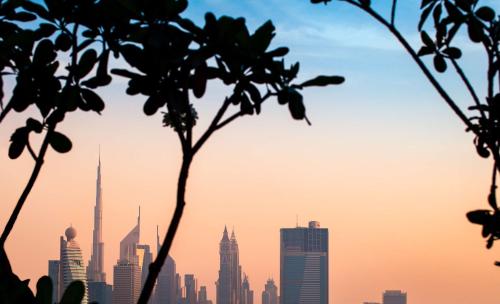 a silhouette of a city skyline with tall buildings at DoubleTree by Hilton Dubai M Square Hotel & Residences in Dubai