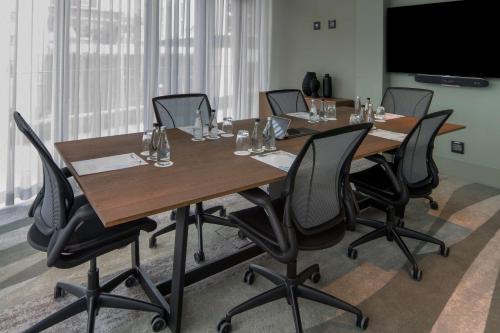a conference room with a long table and chairs at Hilton Garden Inn Umhlanga Arch in Durban
