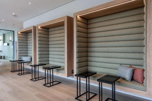 a row of tables and stools in a room at Hilton Garden Inn Umhlanga Arch in Durban