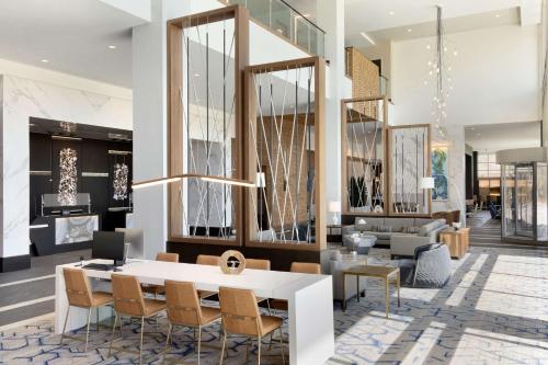 a dining room with a white table and chairs at Hilton Alpharetta Atlanta in Alpharetta