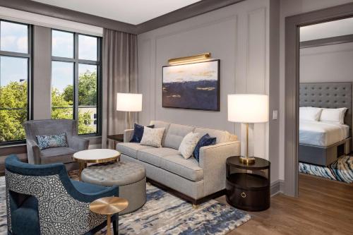 a living room with a couch and a bed at Hilton Club Liberty Place Charleston in Charleston
