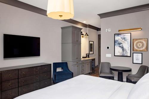 a bedroom with a bed and a flat screen tv at Hilton Club Liberty Place Charleston in Charleston
