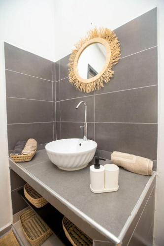 a bathroom with a sink and a mirror on a counter at Dar Moghal in Tiflet