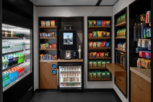 a grocery store aisle with an open refrigerator at Courtyard by Marriott New York World Trade Center Area in New York