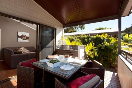 a patio with a table and chairs on a balcony at NRMA Treasure Island Holiday Resort in Gold Coast